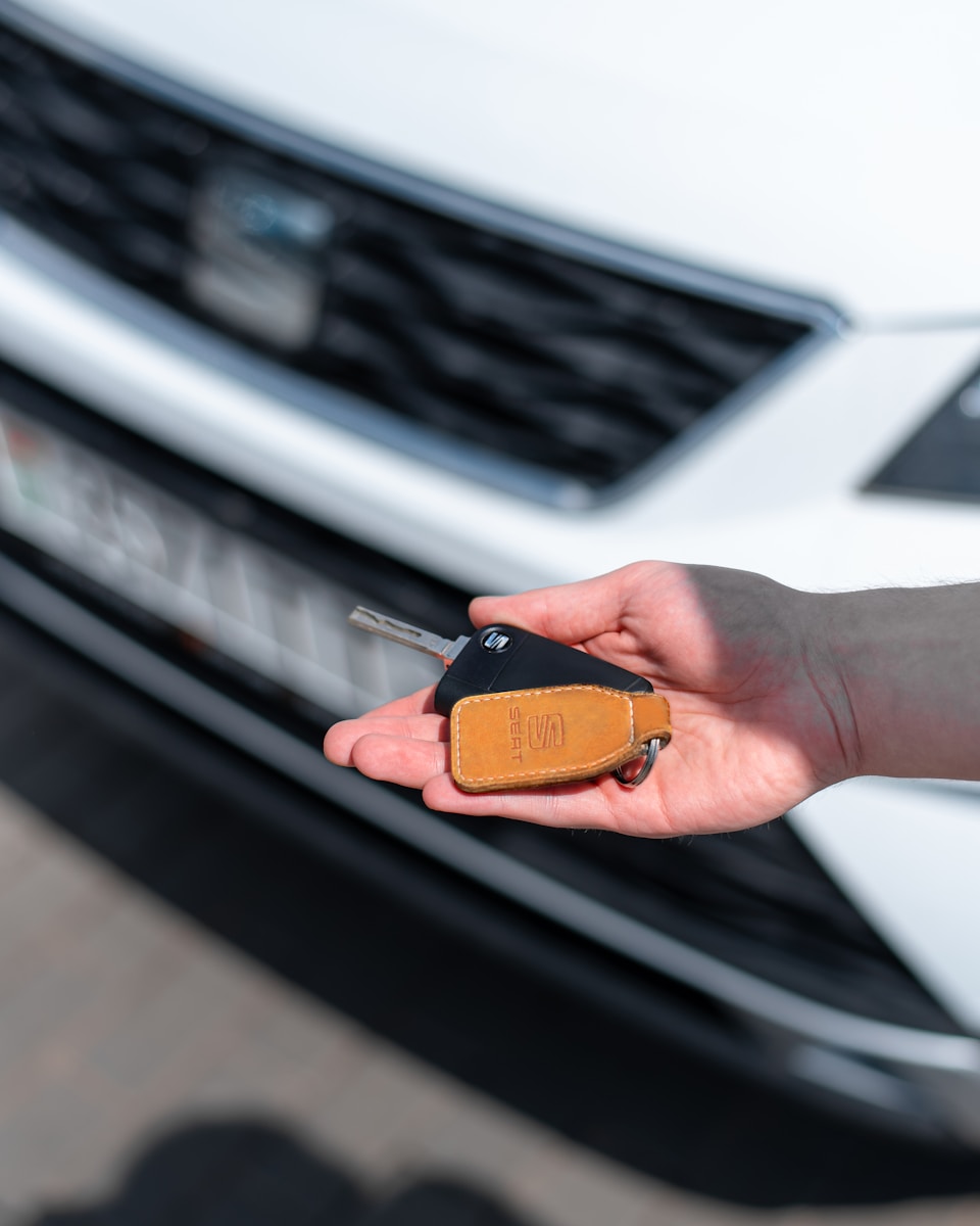 a person holding a car key in their hand